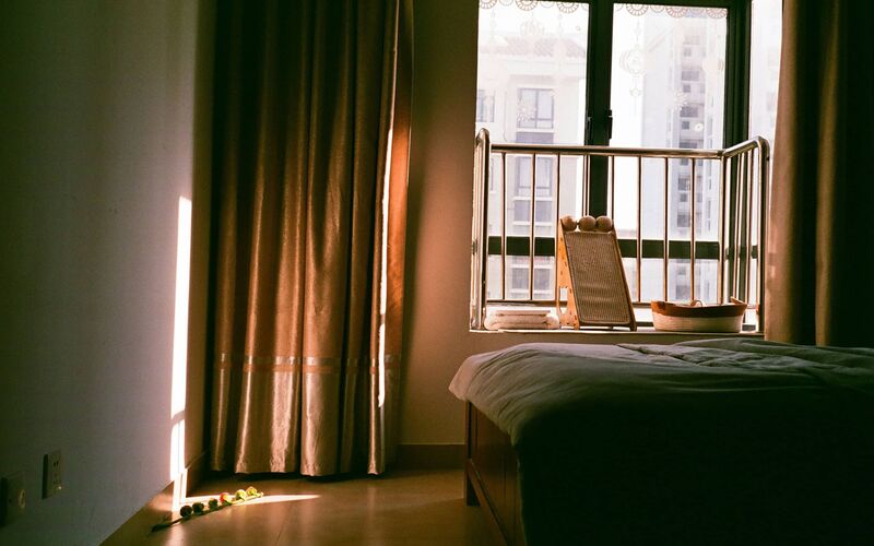 Warm bedroom with curtains and rich tones