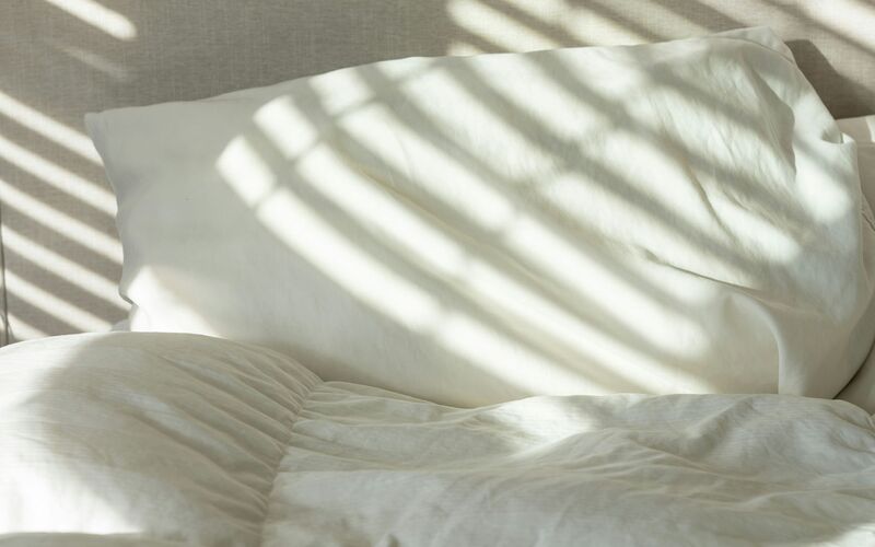 Shadow patterns across white sheets
